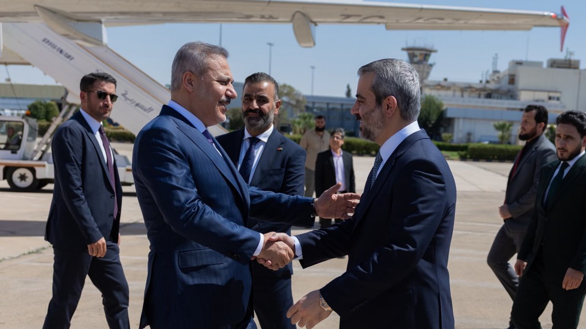 Syrian Foreign Minister Asaad al-Shaibani welcomes Turkish Foreign Minister Hakan Fidan (L) at the airport, in Damascus, Syria, September 13, 2026. (AA Photo) 