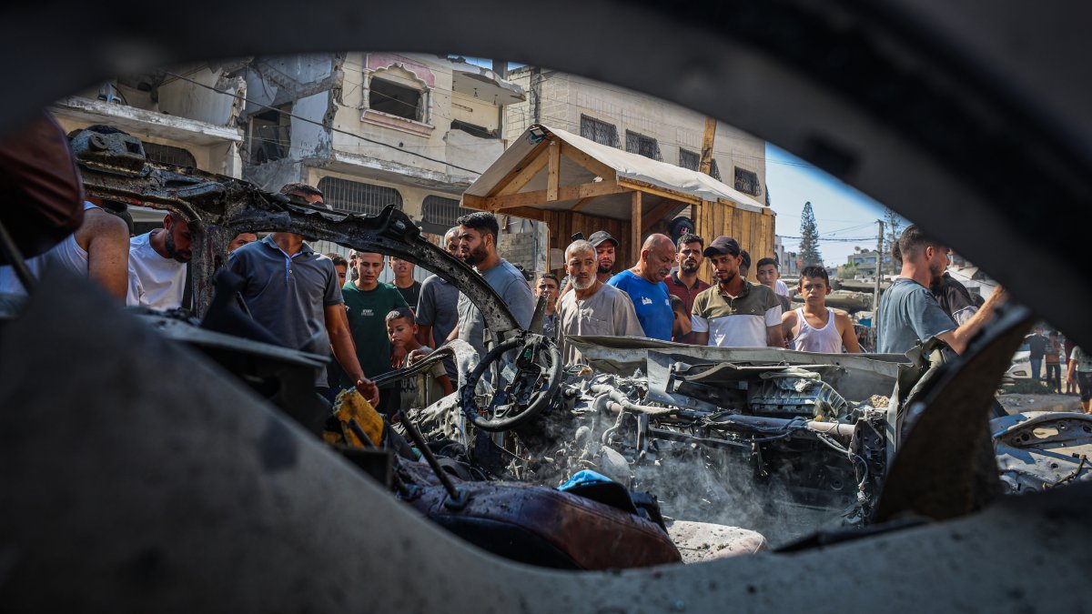 People gather around the vehicle destroyed in an Israeli attack that killed two people in Tel al-Hawa neighborhood of western Gaza City, Palestine, Sept. 13, 2026. (AA Photo)