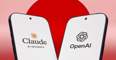 Claude by Anthropic and OpenAI logos are seen on smartphone screens in this illustration. (Shutterstock Photo)