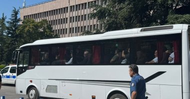A police bus transports Alihan Kuriş and other suspects after their arrest, Ankara, Türkiye, Aug. 16, 2026. (AA Photo)