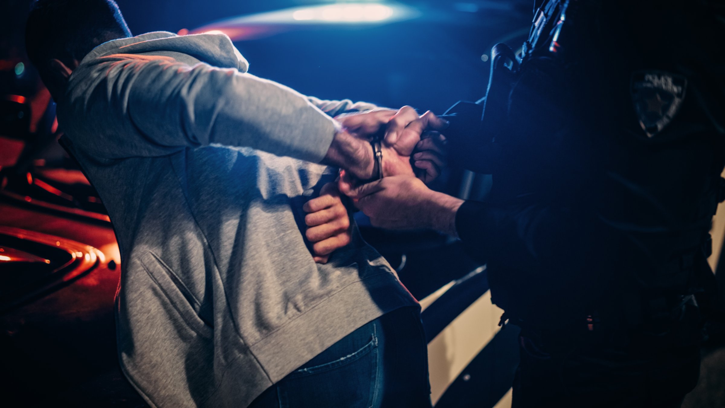 Police officers detain a suspect during an operation targeting criminal organizations. (Shutterstcok Photo)