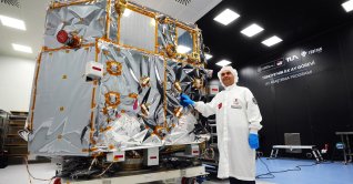 Industry and Technology Minister Mehmet Fatih Kacır poses in front of a spacecraft developed for Türkiye's first Moon mission, Ankara, Türkiye, Sept. 14, 2026. (AA Photo)