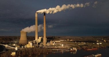 A barge on the Ohio River moves past the Mountaineer Power Plant, a coal-fired power plant near New Haven, U.S., March 13, 2026. (AP Photo)