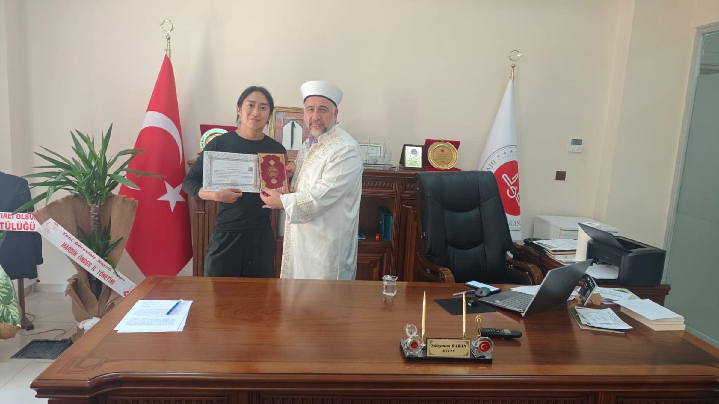 South Korean tourist Shaevn (L) embraces Islam during a ceremony, Mardin, Türkiye, Sept. 14, 2026. (AA Photo)