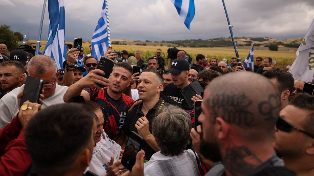 Former lawmaker of the far-right Golden Dawn party, Ilias Kasidiaris takes selfies with his supporters, following his release from jail after serving his term, in Domokos, Greece, Sept. 15, 2026. (Reuters Photo)