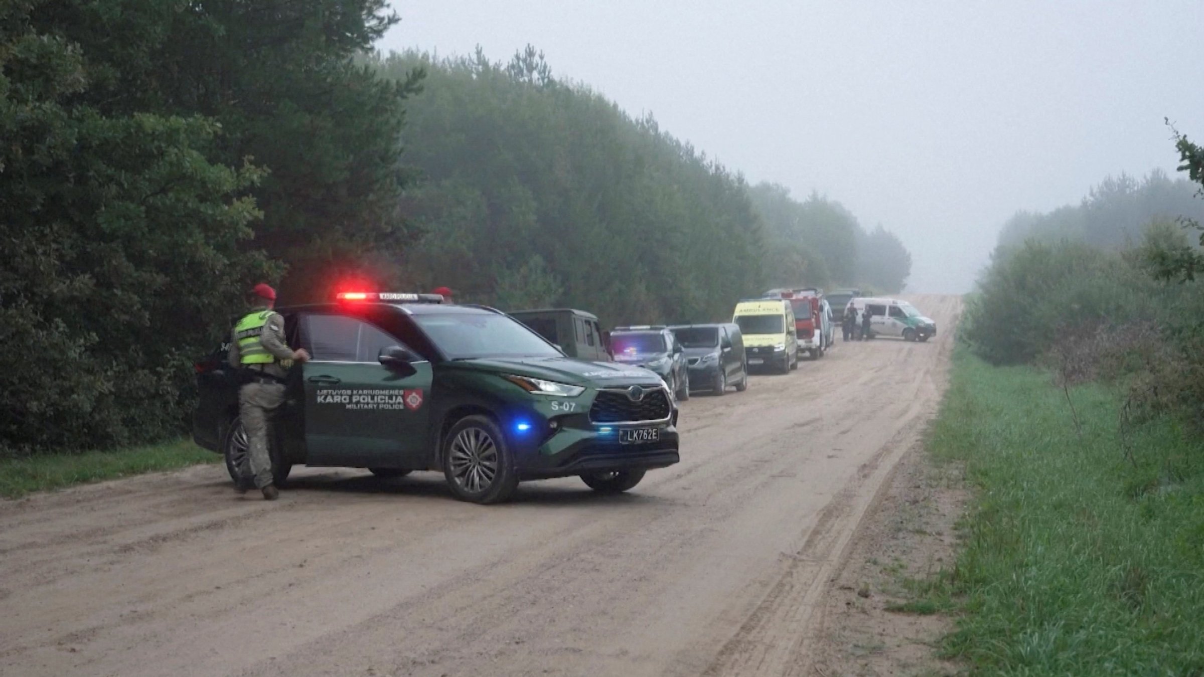 Military police and response vehicles stand parked near the site where, according to the Lithuanian National Crisis Management Centre, a NATO fighter jet shot down a drone near Pratkunai village, Lithuania, Sept. 15, 2026. (Handout via Reuters)