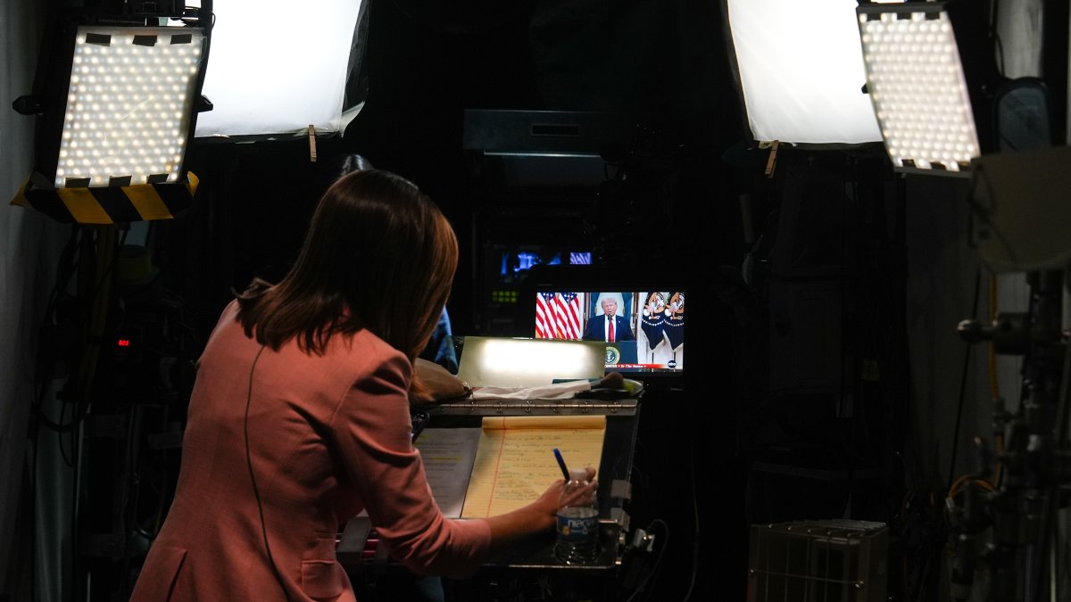 A journalist prepares for a stand-up as President Donald Trump speaks about the Iran war at the White House, April 1, 2026, in Washington. (AP File Photo)