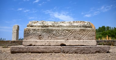 A child’s gravestone featuring a çovgan motif is seen at the historic Seljuk Cemetery, Gevaş district, Van, eastern Türkiye, July 30, 2026. (AA Photo)