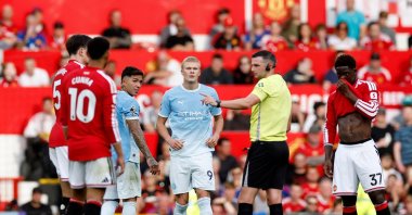 Manchester City's Erling Haaland (C) reacts as referee Michael Oliver awards their first goal following a VAR review during the Premier League match against Manchester United at Old Trafford, Manchester, U.K., Sept. 13, 2026. (Reuters Photo)