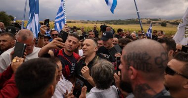 Former lawmaker of the far-right Golden Dawn party, Ilias Kasidiaris takes selfies with his supporters, following his release from jail after serving his term, in Domokos, Greece, Sept. 15, 2026. (Reuters Photo)