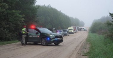Military police and response vehicles stand parked near the site where, according to the Lithuanian National Crisis Management Centre, a NATO fighter jet shot down a drone near Pratkunai village, Lithuania, Sept. 15, 2026. (Handout via Reuters)