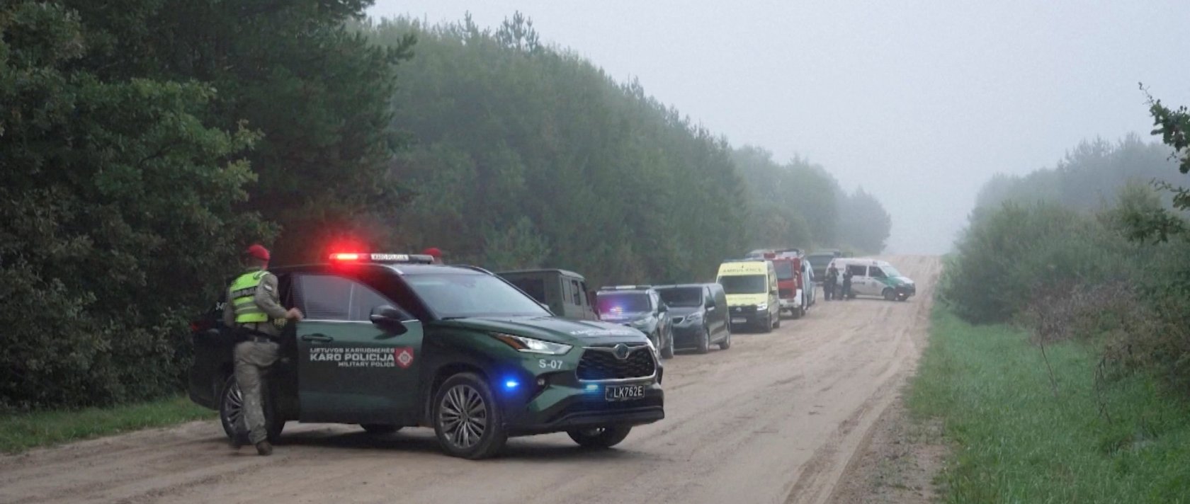Military police and response vehicles stand parked near the site where, according to the Lithuanian National Crisis Management Centre, a NATO fighter jet shot down a drone near Pratkunai village, Lithuania, Sept. 15, 2026. (Handout via Reuters)