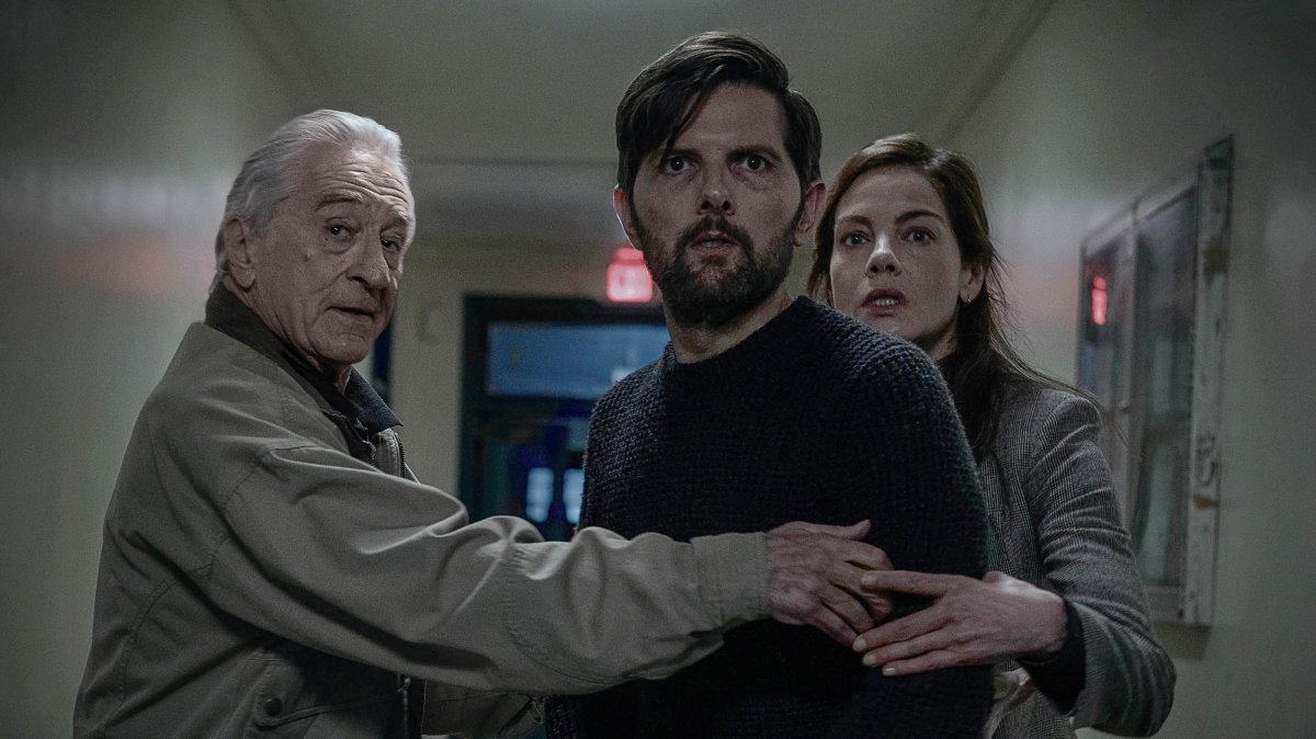 This image released by Netflix shows Robert De Niro (L)  Adam Scott (C) and Michelle Monaghan in a scene from "The Whisper Man." (AP Photo)