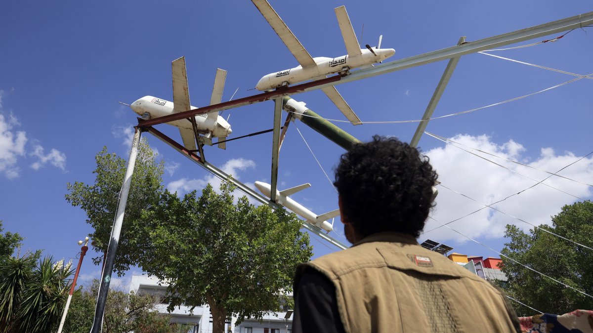 A person passes by a display of Houthi-made mock drones and missiles at a square in Sanaa, Yemen, Sept. 14, 2026. (EPA Photo)