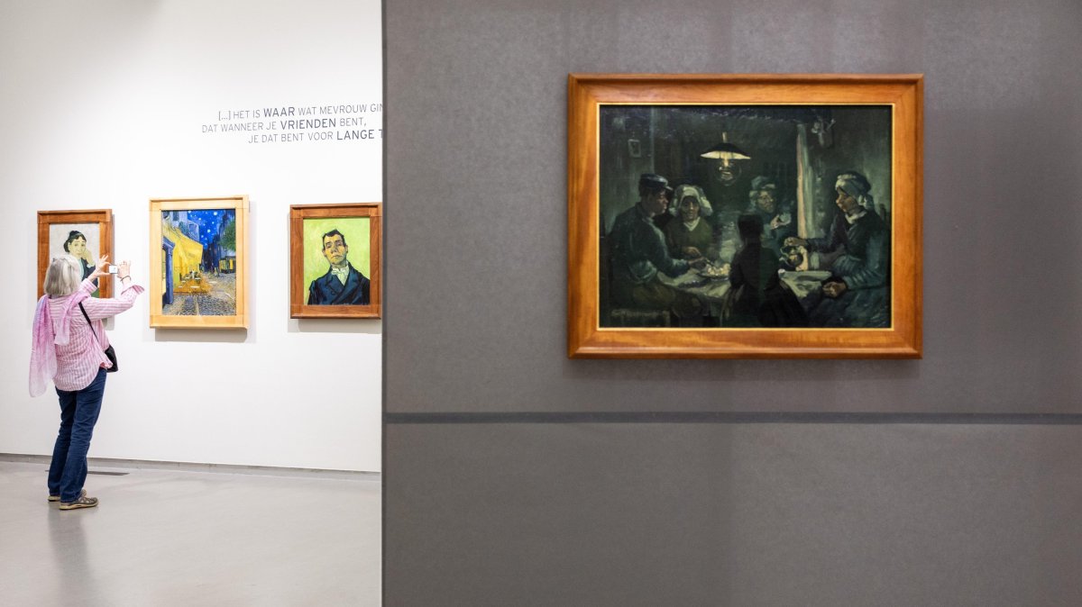 A visitor views the paintings (L-R) "Madame Ginoux," "Cafe Terrace at Night," "Portrait of Joseph-Michel Ginoux" and a preliminary study of "The Potato Eaters" by Vincent Van Gogh at the Kroller-Muller Museum, Otterlo, Netherlands, Sept. 15, 2026. (EPA Photo)