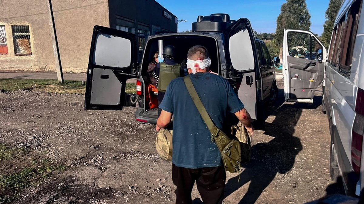 Ukrainian rescuers help passengers of a regular intercity minibus damaged following a Russian drone strike in the Nikopol district of Dnipropetrovsk region, Ukraine, Sept. 16, 2026. (AFP Photo)
