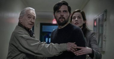 This image released by Netflix shows Robert De Niro (L)  Adam Scott (C) and Michelle Monaghan in a scene from "The Whisper Man." (AP Photo)