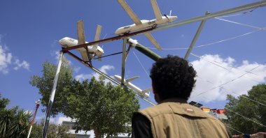 A person passes by a display of Houthi-made mock drones and missiles at a square, Sanaa, Yemen, Sept. 14, 2026. (EPA Photo)