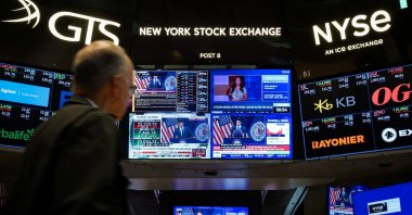 A trader works, as screens broadcast a press conference by U.S. Federal Reserve Chair Kevin Warsh following the Fed rate announcement, on the floor of the New York Stock Exchange (NYSE) in New York City, U.S., July 29, 2026. (Reuters File Photo)