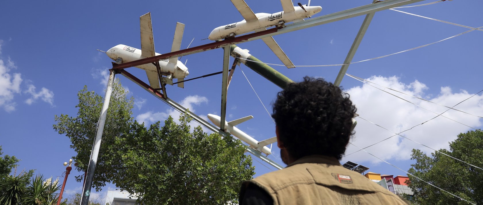A person passes by a display of Houthi-made mock drones and missiles at a square in Sanaa, Yemen, Sept. 14, 2026. (EPA Photo)