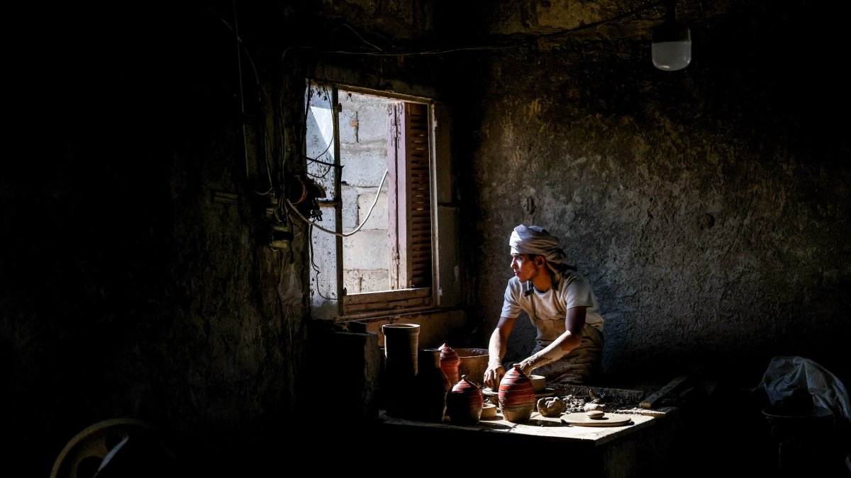 Hamad Yahya Jasim works on a pottery piece at his workshop in the Deir el-Zour countryside, Syria, Sept. 10, 2026. (AA Photo)