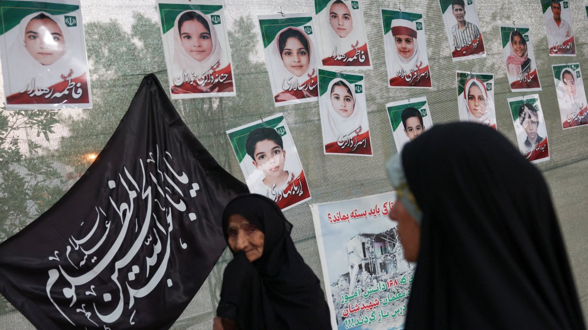 Women are seen in front of images of Minab school students who were killed in a U.S. strike on Feb. 28 in Minab, Iran, Aug. 27, 2026. (Reuters Photo)