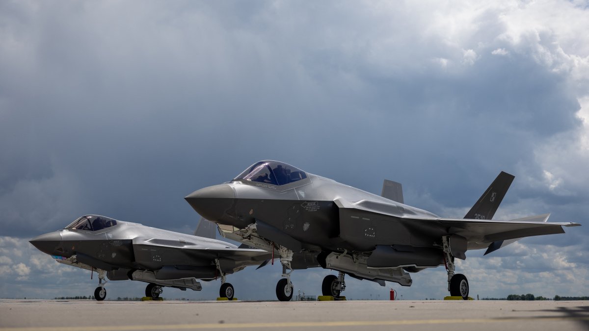 Two U.S.-made F-35 aircraft (Polish codename Husarz) of the Polish Air Force are seen parked on the tarmac at the 32nd Tactical Air Base in Lask, central Poland, June 12, 2026. (AFP File Photo)