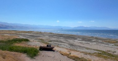 A boat and exposed lakebed are seen in the Lake Van basin following a decline in water levels despite increased rainfall, Van, eastern Türkiye, Sept. 1, 2026. (AA Photo)