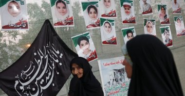 Women are seen in front of images of Minab school students who were killed in a U.S. strike on Feb. 28 in Minab, Iran, Aug. 27, 2026. (Reuters Photo)