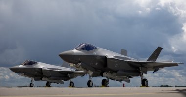 Two U.S.-made F-35 aircraft (Polish codename Husarz) of the Polish Air Force are seen parked on the tarmac at the 32nd Tactical Air Base in Lask, central Poland, June 12, 2026. (AFP File Photo)