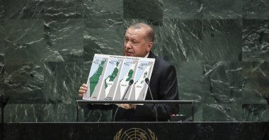 President Recep Tayyip Erdoğan holds up a map of Palestine since 1947 showing the changing population of the territory under Israeli occupation while speaking to the United Nations General Assembly, New York City, U.S., Sept. 24, 2019. (Getty Images Photo)