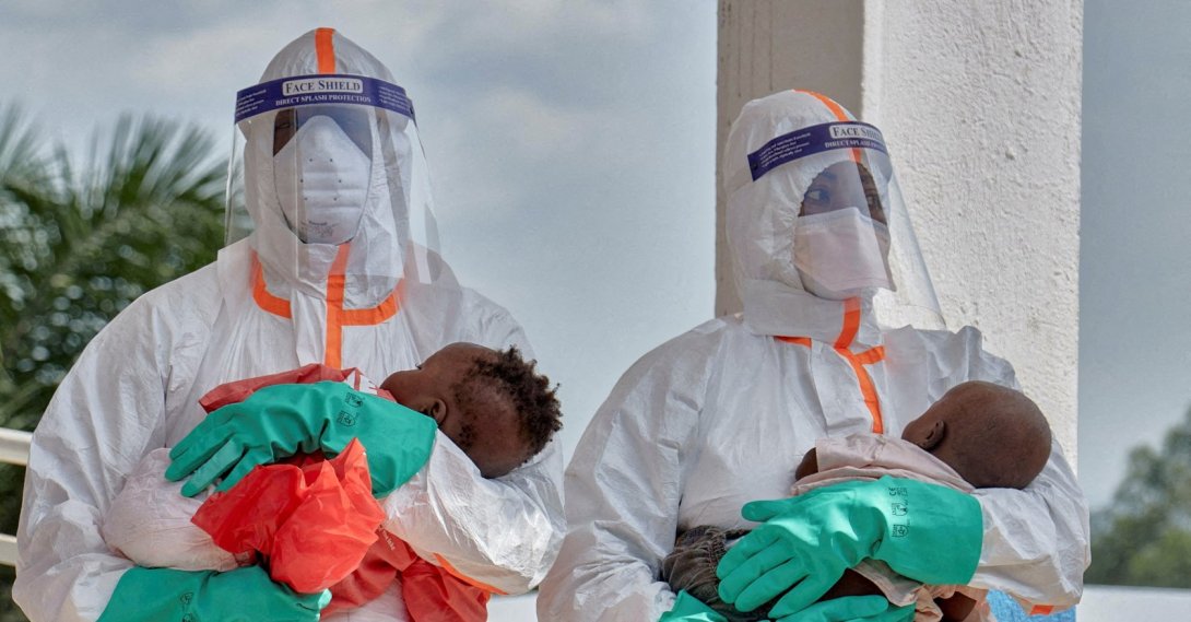 DRC medical workers dressed in personal protective equipment (PPE) carry children tested and cleared of Ebola from Saint Nicholas Orphanage, Bunia, DRC, June 9, 2026. (Reuters Photo)