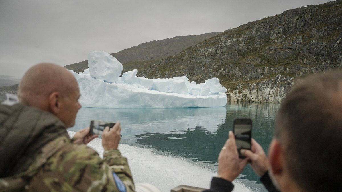 Danish Minister of Defense Jeppe Bruus (R) takes a picture of an iceberg as he visits the NATO military exercise Arctic Shield 2026 in Narsarsuaq, Greenland, Sept. 9, 2026. (EPA Photo)
