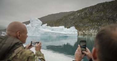 Danish Minister of Defense Jeppe Bruus (R) takes a picture of an iceberg as he visits the NATO military exercise Arctic Shield 2026 in Narsarsuaq, Greenland, Sept. 9, 2026. (EPA Photo)