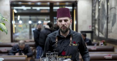 Khaled who immigrated to Germany a year and a half ago due to the war conditions in Syria, works in a Syrian restaurant, Berlin, Germany, Dec. 10, 2024.  (AP Photo)
