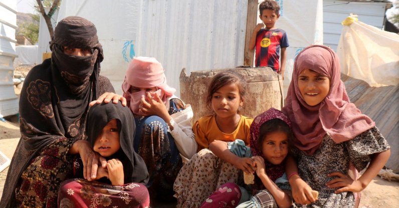 Rawya Hassan, a mother of seven, sits with her children outside their hut at the al-Bireen camp for displaced people who fled fighting between the Houthis and forces of Yemen's internationally recognized government, Taiz province, Yemen, Sept. 17, 2026. (Reuters Photo)