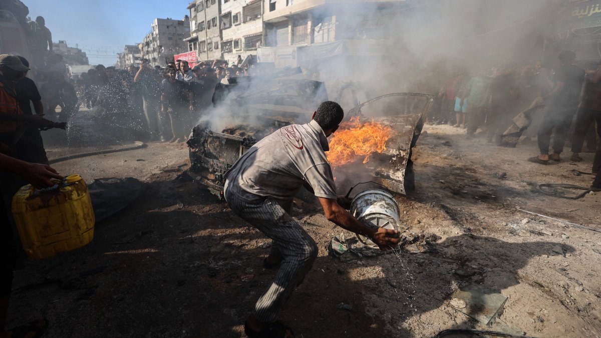 Palestinians attempt to extinguish a burning vehicle that was struck by an Israeli airstrike in Gaza City, Palestine, Sept. 19, 2026. (AFP Photo)