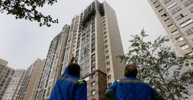 A man points at a damaged multistory residential building hit by Ukrainian drone strike in Kotelniki, Moscow region, Russia, Sept. 20, 2026. (Reuters Photo)