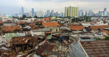 Dense urban housing with modern skyscrapers in the background, highlighting social and economic contrast, Jakarta, Indonesia, Dec. 3, 2022. (Shutterstock Photo)