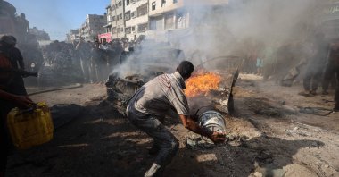 Palestinians attempt to extinguish a burning vehicle that was struck by an Israeli airstrike in Gaza City, Palestine, Sept. 19, 2026. (AFP Photo)