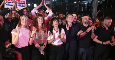 Elif Eralp (C) joins fellow party members and supporters in celebrating the election results, Berlin, Germany, Sept. 20, 2026. (AA Photo)