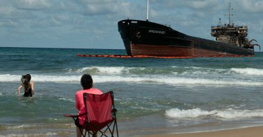 People swim next to the Russian-flagged cargo ship “OMSKIY-107,” which was attacked off the coast of Russia, drifted and ran aground off the shore of Şile, Istanbul, Türkiye, Sept. 3, 2026. (AFP Photo)