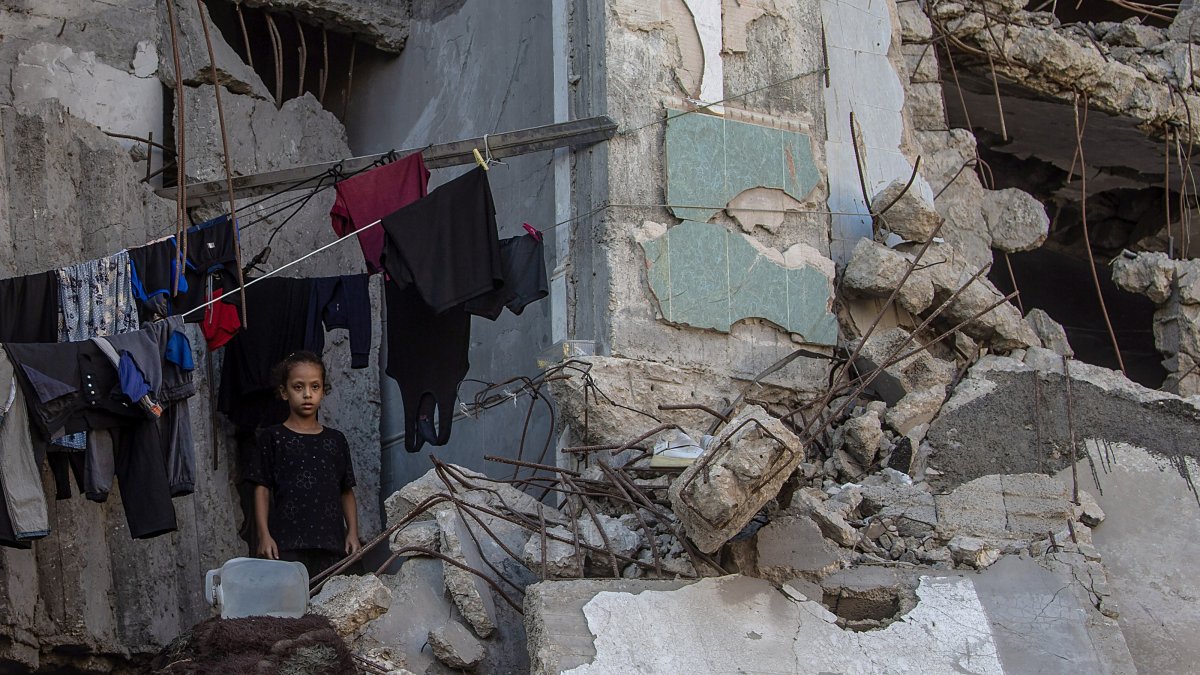 A displaced Palestinian girl stands next to hanging clothes inside a damaged building where she lives with her family, Gaza City, Gaza Strip, Palestine, Sept. 21, 2026. (EPA Photo)