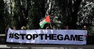 Protestors holding a 'Stop The Game' banner at a protest for stopping the Ireland-Israel Nations League game, on Frank Flood bridge, before the SSE Airtricity Men's Premier Division match between Shelbourne and Shamrock Rovers at Tolka Park, Dublin , Ireland, June 12, 2026. (Getty Images Photo) 