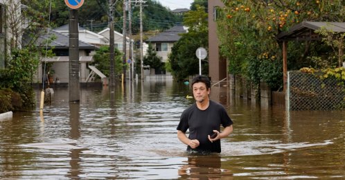 A man wades through a flooded road after Typhoon Dujuan brought torrential rain to Sakura, Chiba prefecture, Japan, Sept. 22, 2026. (Reuters Photo)