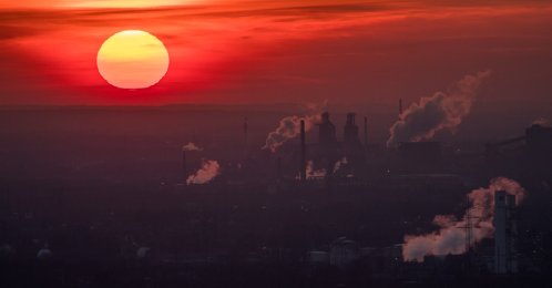 Steam and exhaust rise from different companies while the sun sets, Oberhausen, Germany, Jan. 6, 2017. (Getty Images Photo)