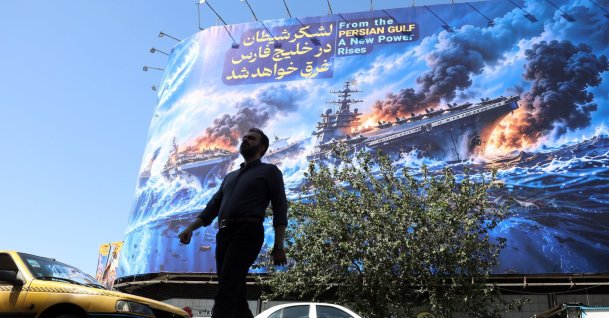 A man walks next to an anti-U.S. billboard carrying a sentence in Persian that reads, "The devil army will be drowned in the Persian Gulf," Tehran, Iran, Sept. 21, 2026. (EPA Photo)
