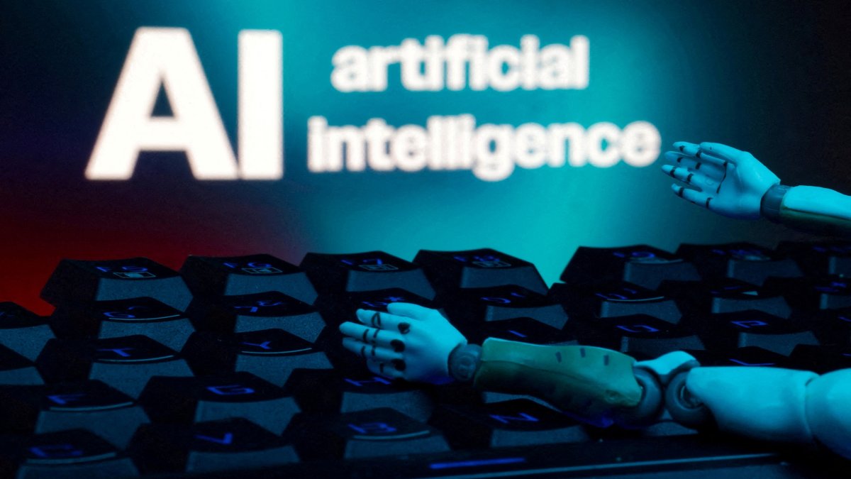 A reading "AI artificial intelligence," a keyboard, and robot hands are seen in this illustration taken Jan. 27, 2025. (Reuters Photo)
