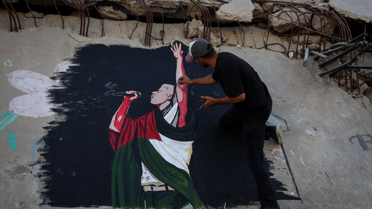 Palestinian artists painted a portrait of American rapper Macklemore on the wall of a destroyed house to thank him for expressing his support for Palestinians in the Gaza Strip, Gaza, Palestine, Sept. 17, 2026. (AA Photo)