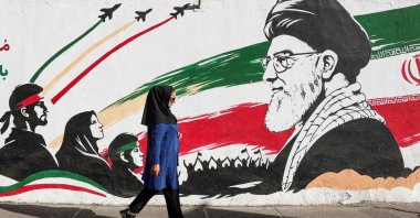 An Iranian woman walks past a mural of Iran's assassinated supreme leader, Ayatollah Ali Khamenei, Tehran, Iran, Sept. 23, 2026. (AFP Photo)